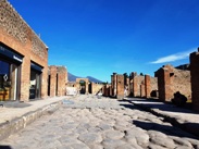 A street in Pompeii with Mt. Vesuvius visible in the background