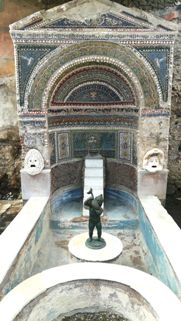 The statue of a putto with a dolphin in the House of the Large Fountain